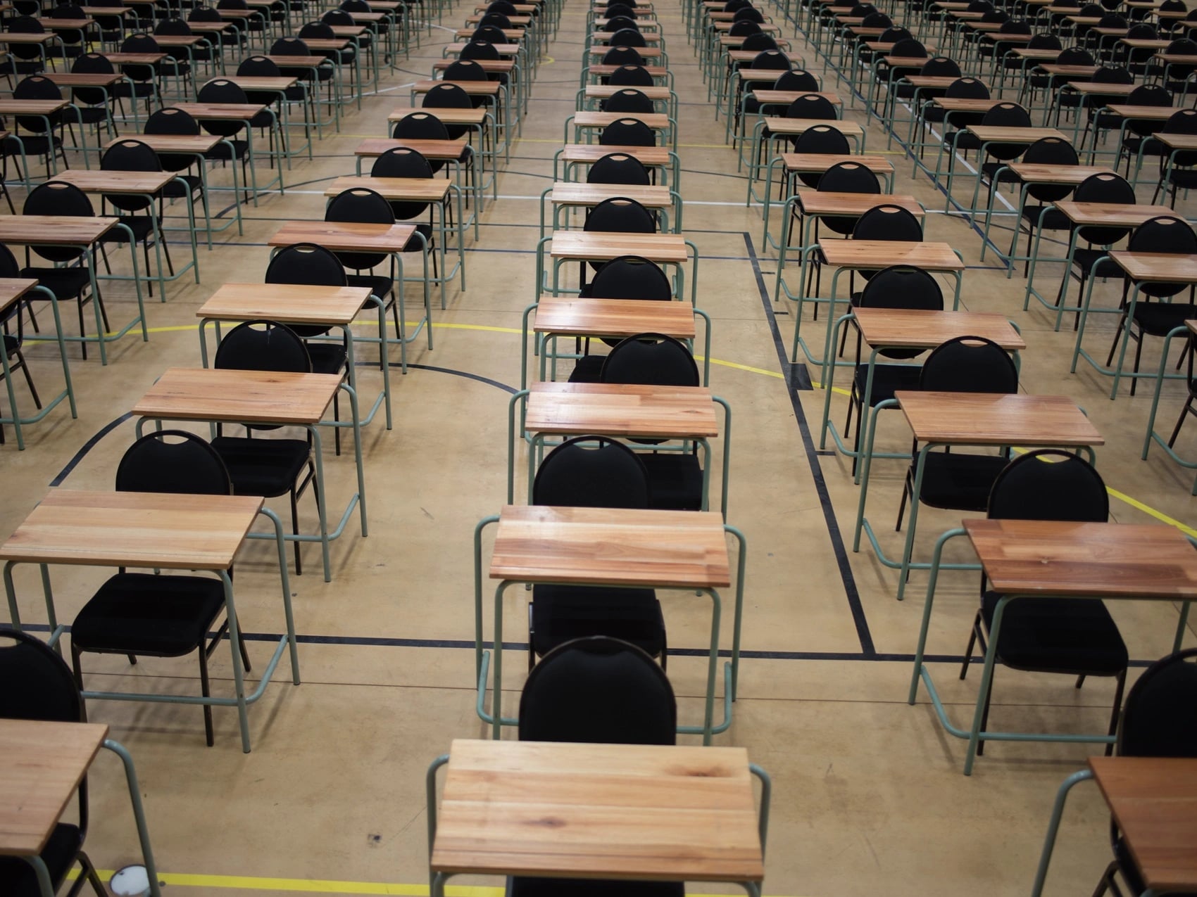Rows of empty desks in a university exam hall where a missed exam may need a medical certificate.