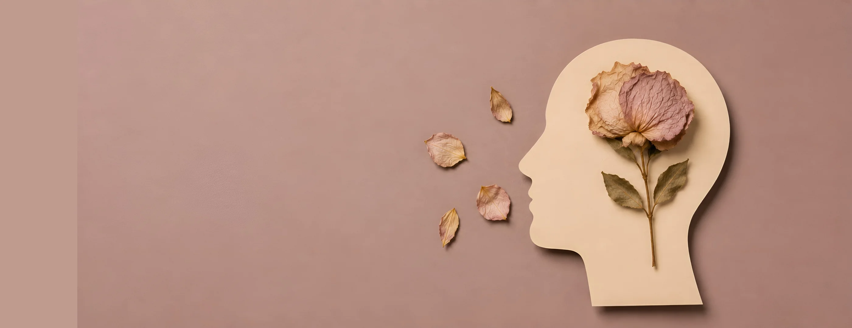 Paper cutout of a head silhouette with a single wilted flower and a few fallen petals inside, representing quiet grief — Sick Leave Certificate for Grief from OMC Health