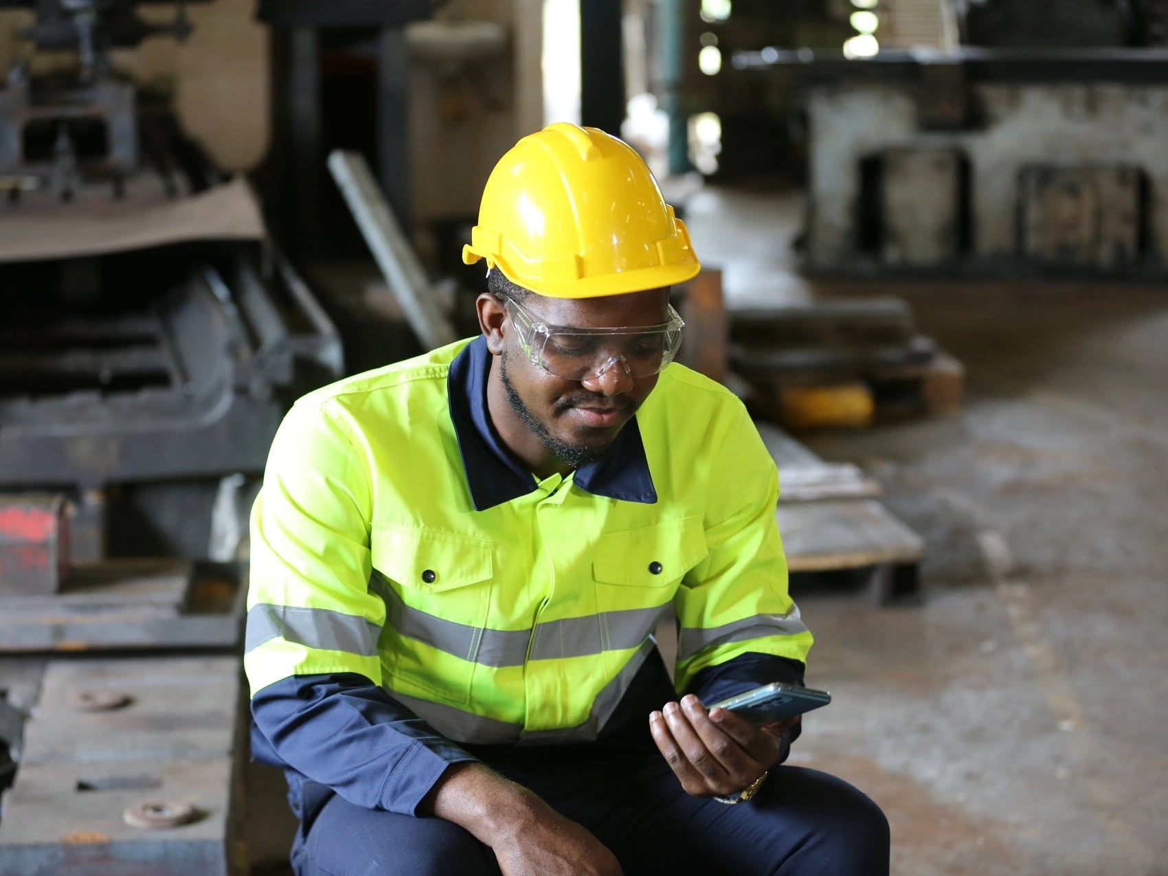 Worker on break using smartphone to book a WorkCover certificate of capacity through OMC Health